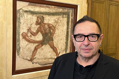 Waldemar in front of wall mural of Priapus - © Matt Conway